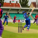 Cricket match scene at GB Oval, Szodliget, Hungary featuring Budapest Kings and DK players in action with overcast weather and a cheering audience for BK vs DK Dream11 Prediction